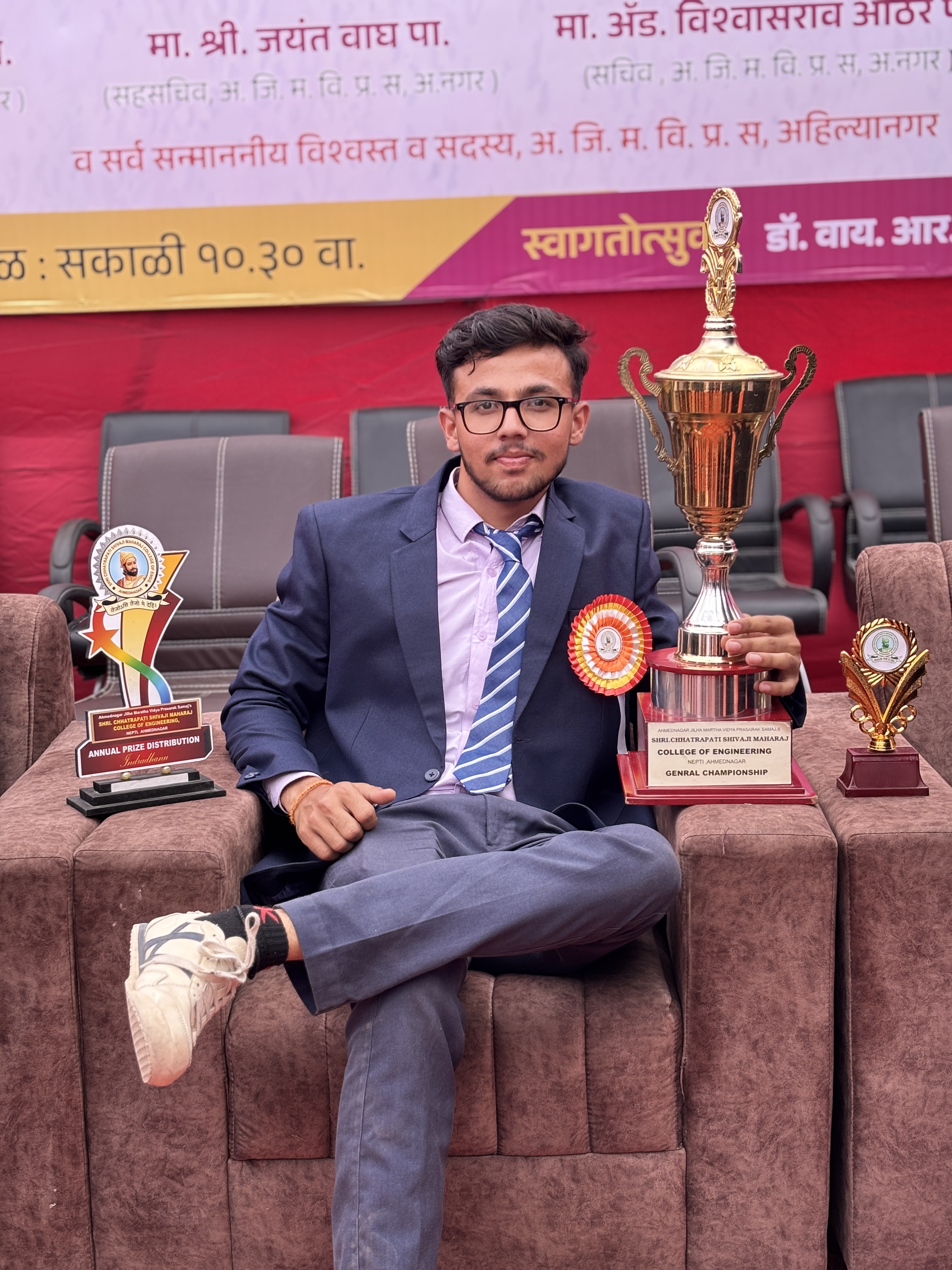 Onkar Kandekar seated with the General Championship trophy and annual prize distribution awards