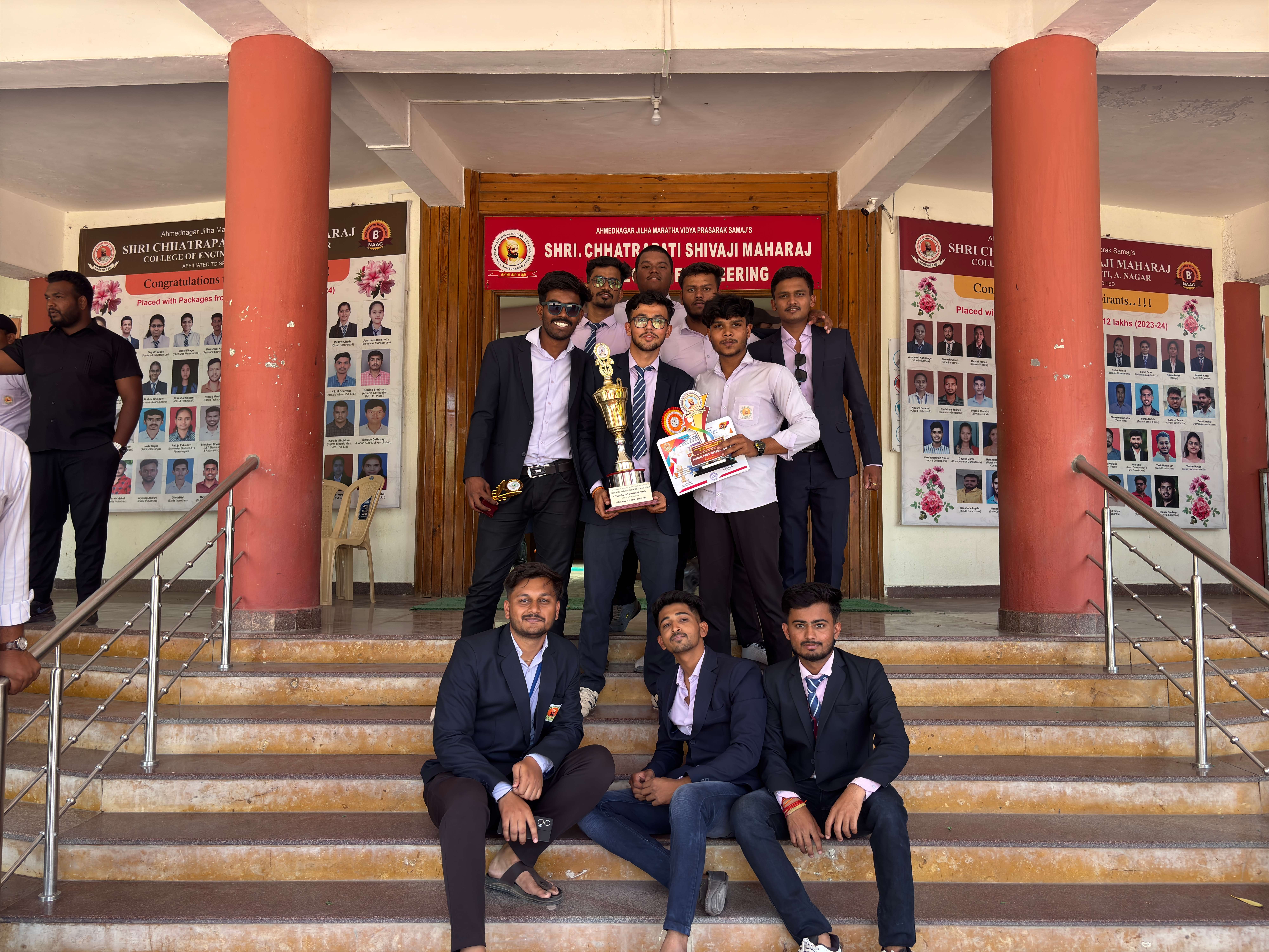 Onkar Kandekar with his team holding the General Championship trophy on the college steps